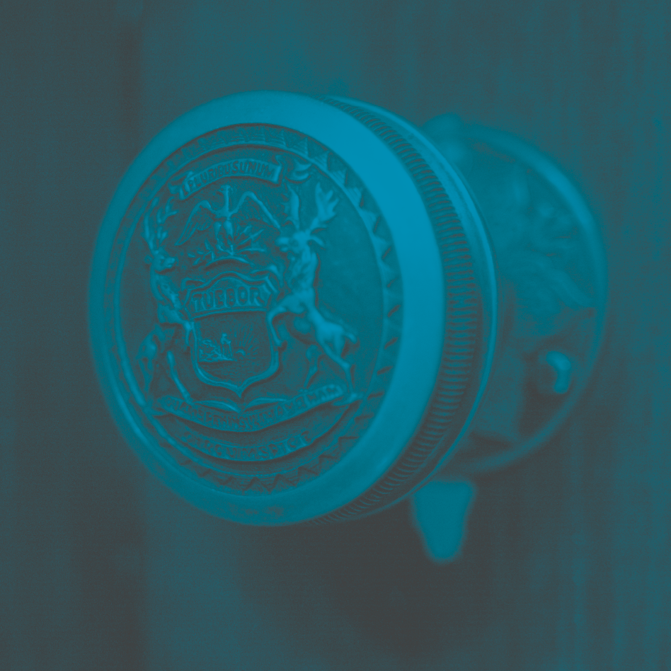 An antique door handle with the Michigan seal on it.