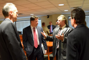 Auburn Hills officials talk with State Rep. Jim Townsend following a House Tax Policy Hearing on the Dark Stores issue Dec. 9, 2015.