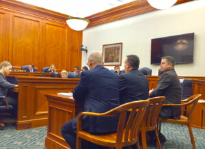 The League's Chris Hackbarth (center) testifies in Lansing Wednesday along with Sault Ste. Marie City Manager Oliver Turner (left) and Tecumseh City Manager Dan Swallow (right).