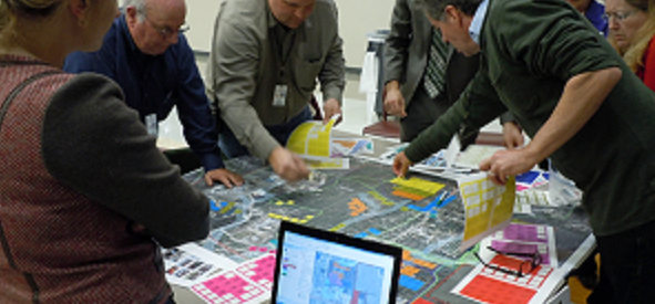 Residents engage in computer-aided planning through Austin Sustainable Place Projects.