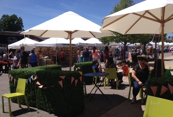Berkley Art Bash attendees take a break on patio furniture rented by the placemaking committee.