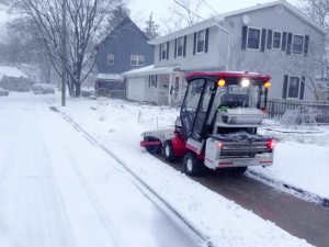 SnowBuddy's tractor can clear the sidewalk in front of a residential lot in approximately 10 seconds. Photo courtesy Paul Tinkerhess.