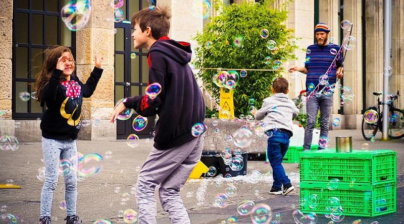 Kids Playing with Bubbles Downtown Photo