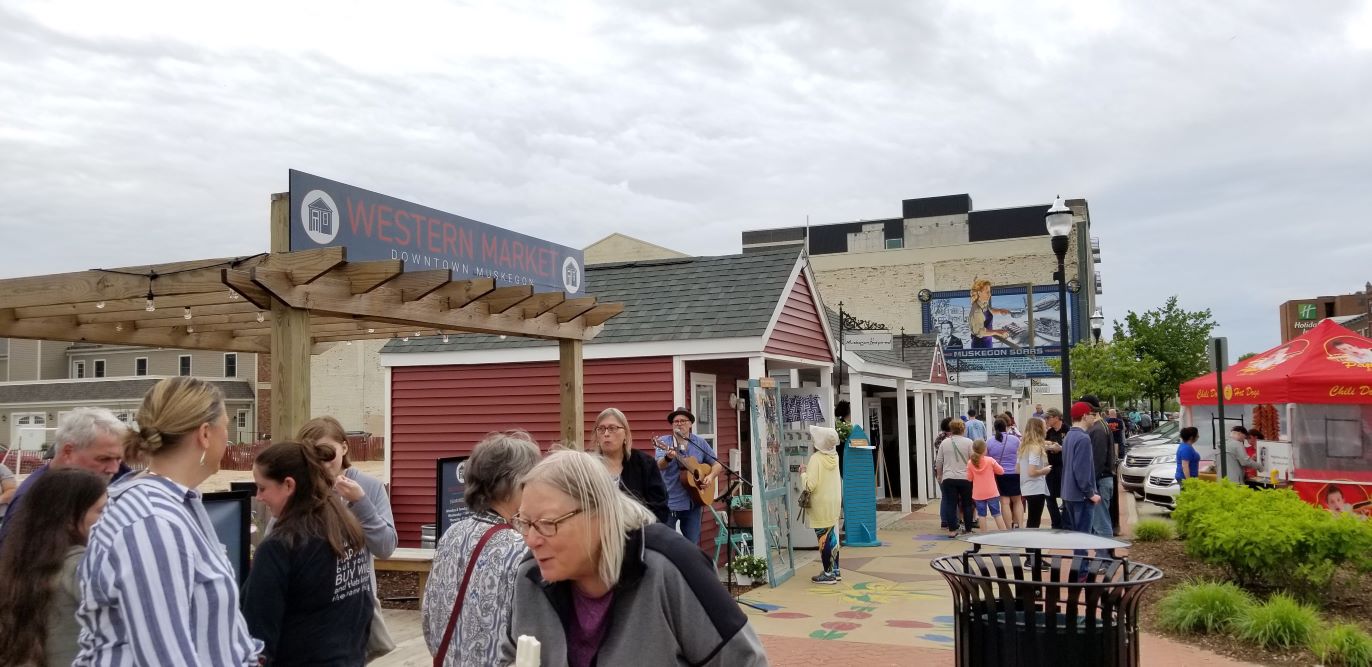 Retail sheds and a sidewalk full of people