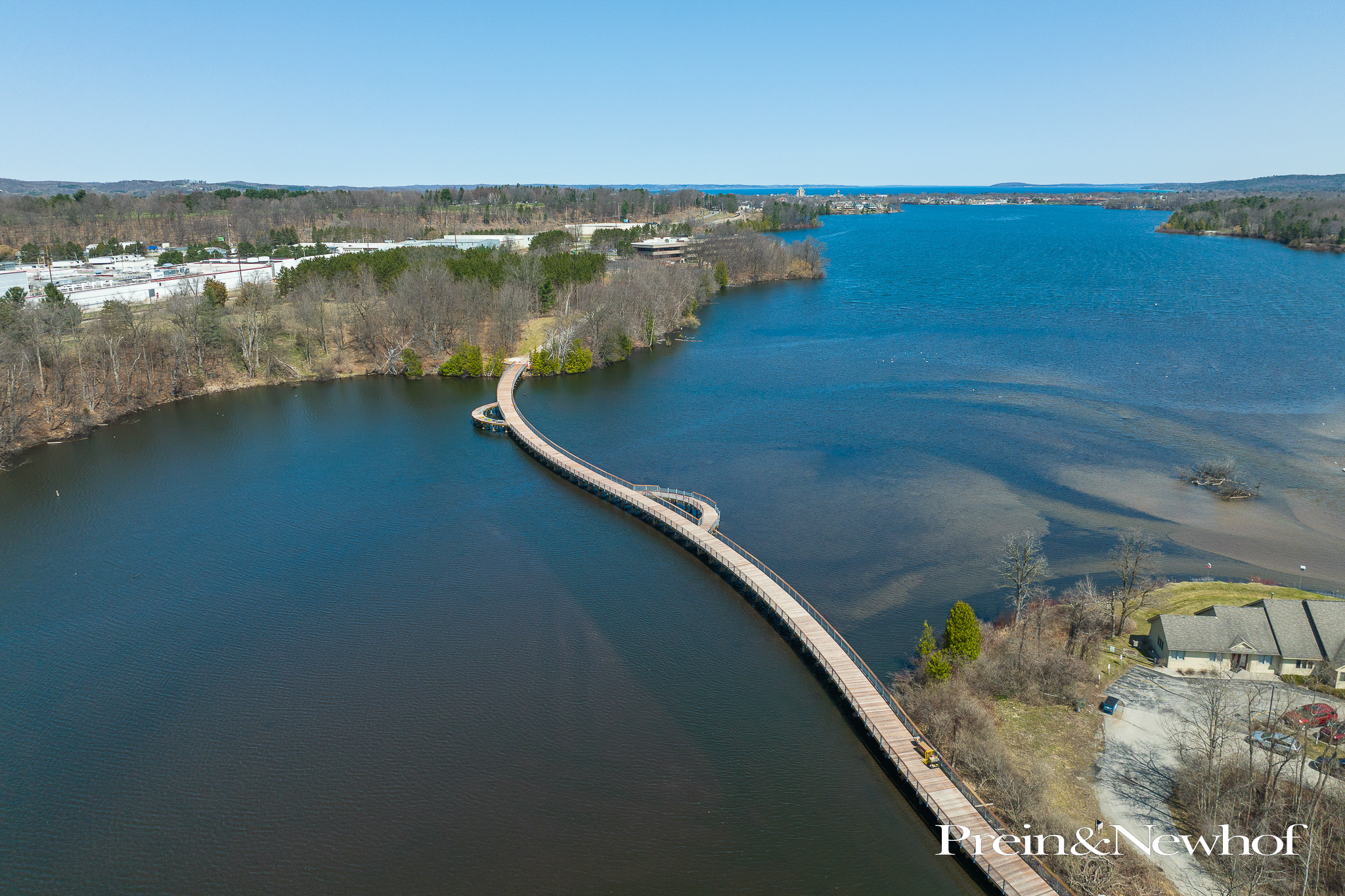 Aerial view of long boardwalk stretching over a body of water.